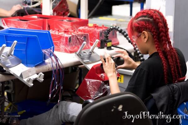 Vitamix factory worker installing faceplates