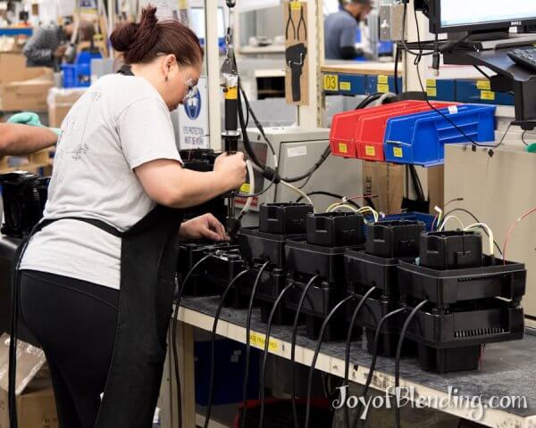 Vitamix factory worker assembling bases