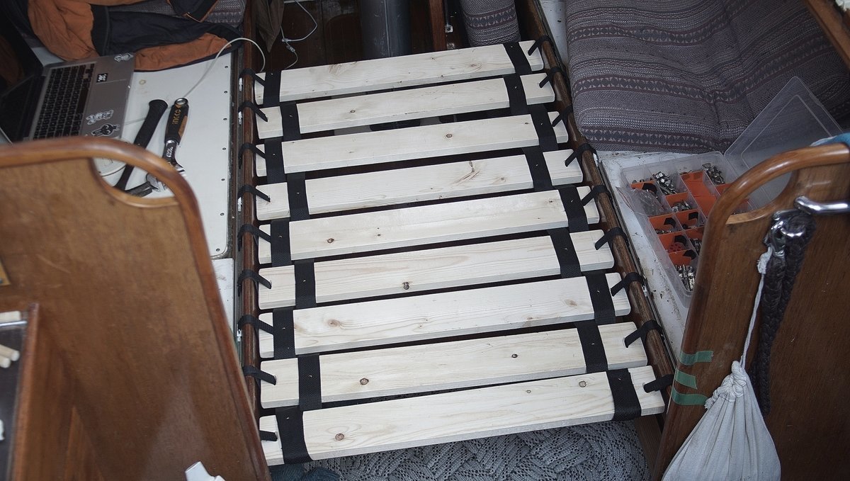 a hanging boat bed made from wooden slats