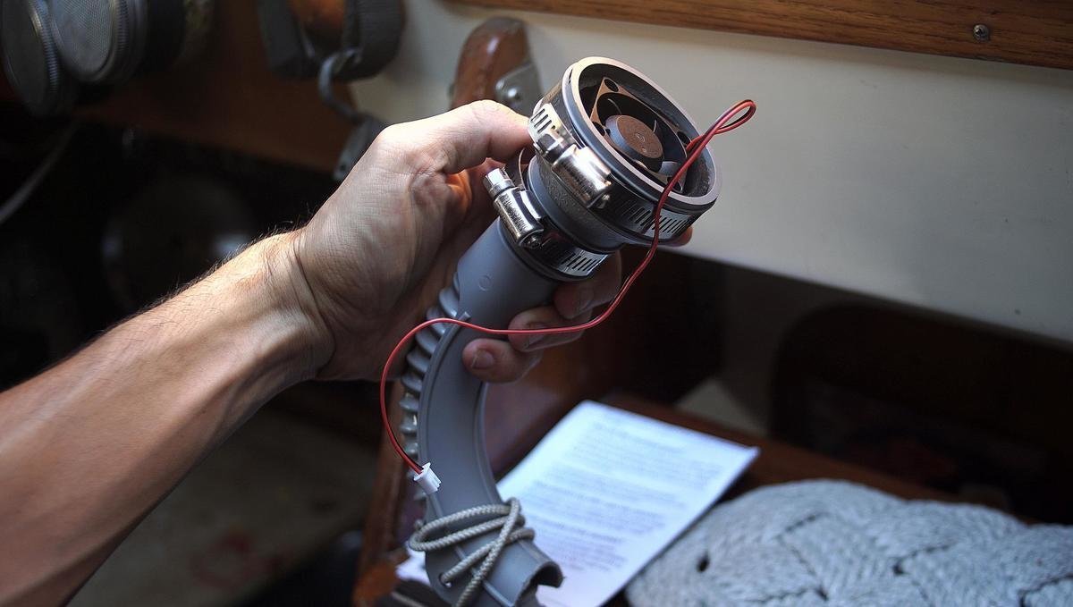 A photo of a hand holding a diy fan housing