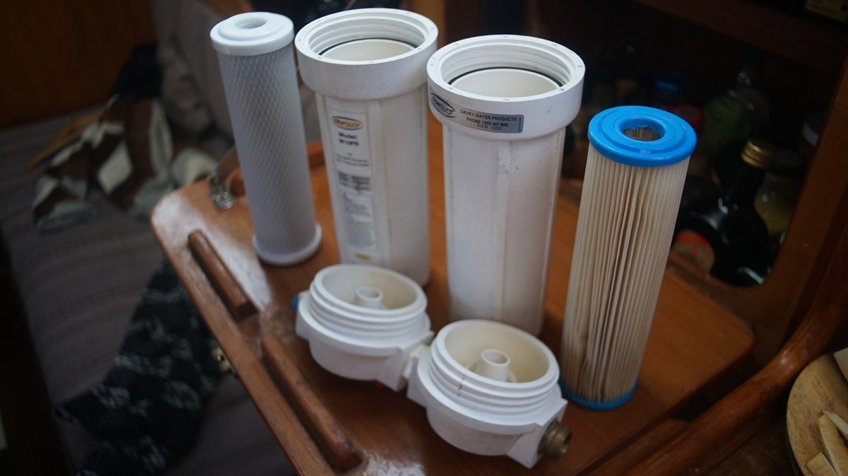 Four cylindrical water filters of different sizes and materials.