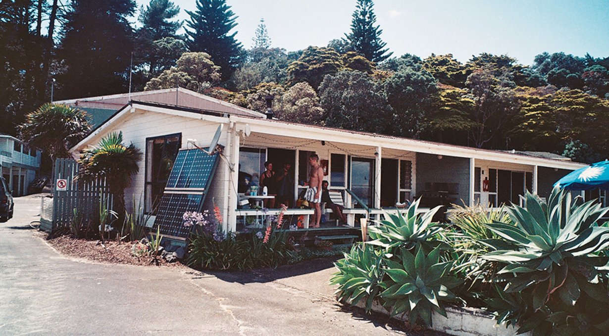 people hanging out on the balcony of a house