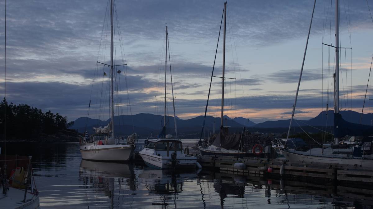 boats laying on a dock in a small marina