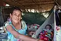 Baby sleeps in a hammock in a hut in Laos.
