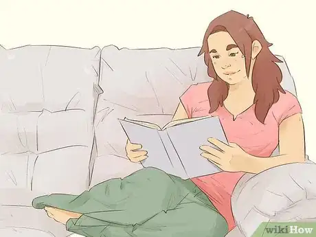 Image titled Woman sitting on a couch reading a book.