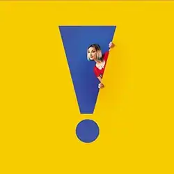 A photo of the artist peeking around the side of an exclamation point-shaped hole in a yellow wall, with a blue wall visible behind her and the hole