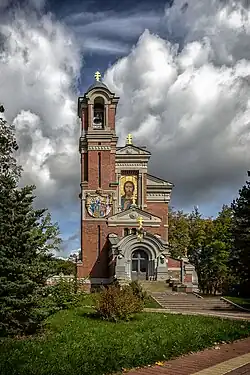 A brick chapel with the image of Christ and golden crosses
