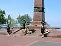 Male and female cadets bowing their heads in respect while guarding the monument