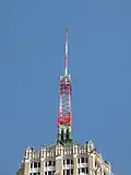 An antenna tower 146 feet (45 m) tall in San Antonio, TX with its red and white aircraft warning paint visible