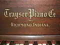 The Trayser logo, just above the keyboard, 1875