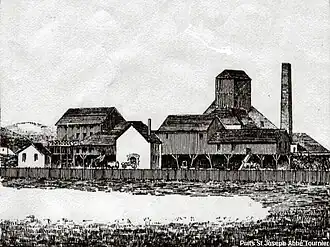The workshops at the Saint-Joseph shaft; behind, the headframe and chimney c. 1884.