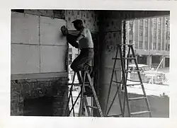 Arthur Barbezat removing Red Jacket mural from wall