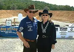 Man and woman, both wearing cowboy hats and sunglasses