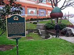 A photo of a commemorative plaque inscribed with the details of the founding of Silver Spring.