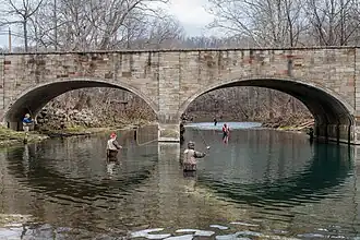 Stone bridge with fishermen