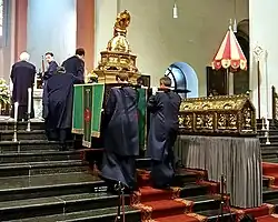 The small processional litter going up the choir stairs