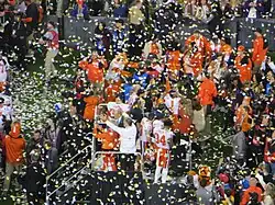 Clemson's coach and players are presented with the championship trophy.