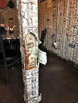 The walls of the Saloon are papered with dollar bills.