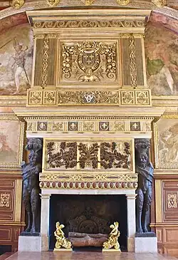 Fireplace in the ballroom, flanked by statues of satyrs