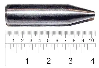 Shiny metallic cylinder with a sharpened tip. The overall length is 9 cm and diameter about 2 cm.