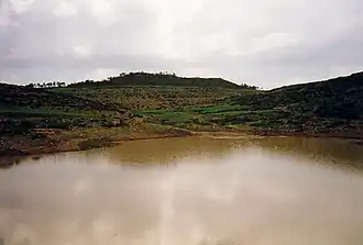 Photograph of the reservoir with a hill in the background