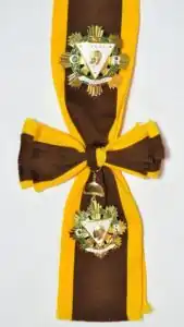 Regalia of a KGCR includes a gold breast star and sash of the Order
