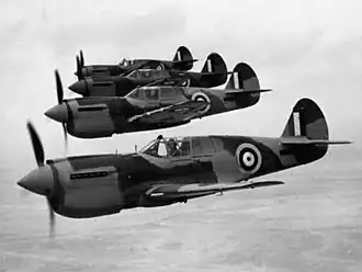 Four single-engined military monoplanes in flight