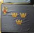 Colour presented in 1935 by His Majesty the King Gustav V in connection with 300th anniversary of Fortifikationen ("Royal Engineers"). The provincial badge of Uppland attached in 1959 in the upper inner corner, where originally the lesser coat of arms of Sweden was.