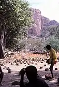 A schoolboy between the sitting stones of the Tireli market, Mali 1984