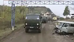 A convoy of Russian peacekeepers driving past an Azerbaijani checkpoint at the northern entrance to Shusha.