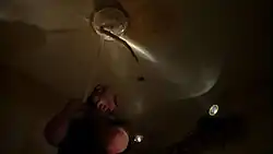 A man is being strangled by a tentacled creature