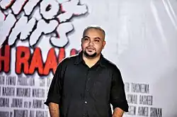 Ahmed Shakir attending the red carpet event of his film "Gohraalhu" wearing a black shirt.