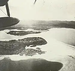 Airplane flying over Gasmata, looking North