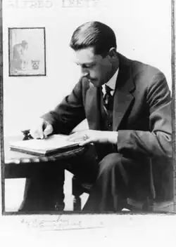 Photograph of Leete drawing at his desk