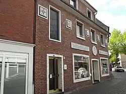 Classic symbols at the wall of a former German pharmacy