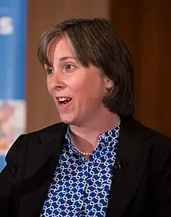 Ann O'Leary speaks in front of a podium