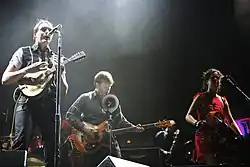 Colour photograph of Arcade Fire performing live in 2007.