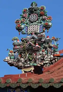 Close-up of the rooftop miniature pagoda and floral carvings.
