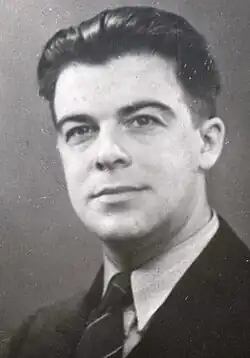 portrait of dark haired man in suit