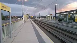 Ashton West tram station at twilight, in the direction of Ashton-under-Lyne in October 2016.