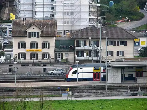 White train at island platform