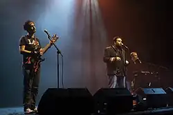 The Axis of Awesome (left to right: Lee Naimo, Jordan Raskopoulos, Benny Davis) performing c. 2011