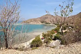 Beach with bay at left and peninsula in the background