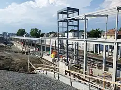A railway platform under construction in an urban area