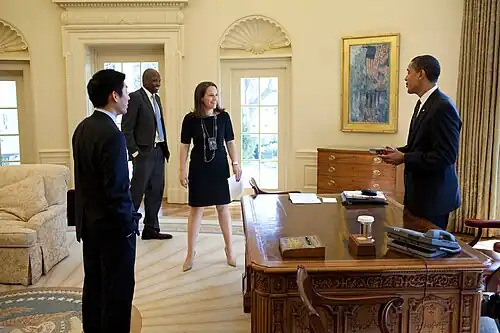 President Barack Obama jokes with Special Assistant Eugene Kang, Personal Secretary Katie Johnson and Personal Aide Reggie Love in the Oval Office.