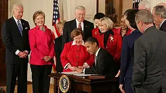 President Obama signing the Lilly Ledbetter Fair Pay Act of 2009. Ledbetter is to the viewer's right of President Obama.