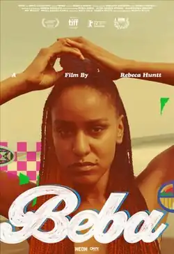 Poster for the film Beba featuring a close-up of a woman with long red braids standing on a beach. She gazes intensely at the camera with her hands on her head. The title appears in bold, white cursive lettering at the bottom, with colorful abstract shapes decorating the background.