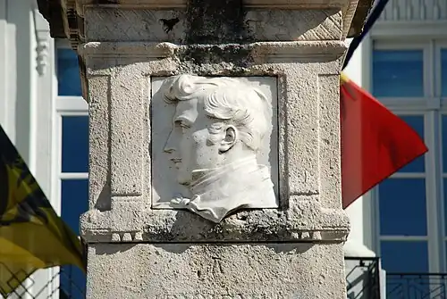 Closeup of white marble plaque with the effigy of Jenneval