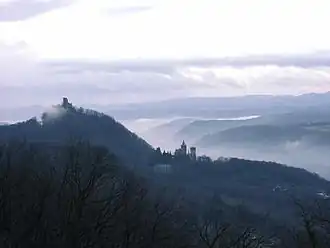 Dawn view from Petersberg into Rhine valley, showing the castle ruins on the Drachenfels and the Schloss Drachenburg