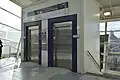 Station lifts from concourse leading to the enclosed waiting room, September 2013